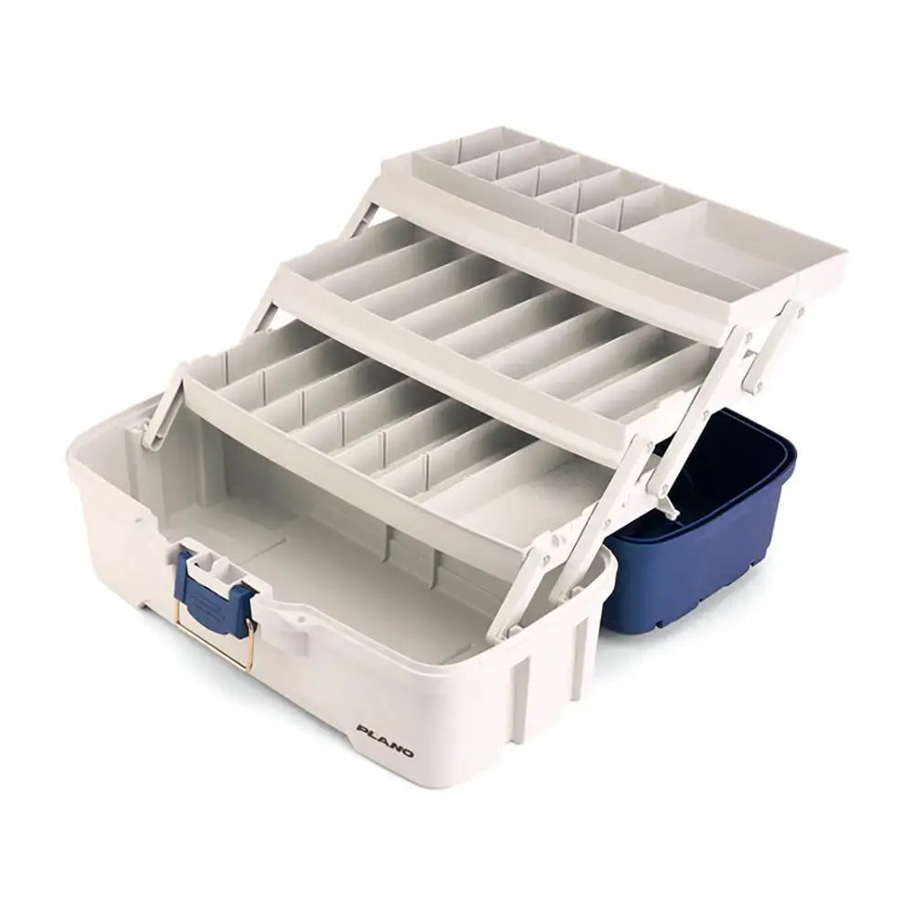Beige plastic plano multi-tiered tackle box with blue latches and navy container for fishing tackle storage.